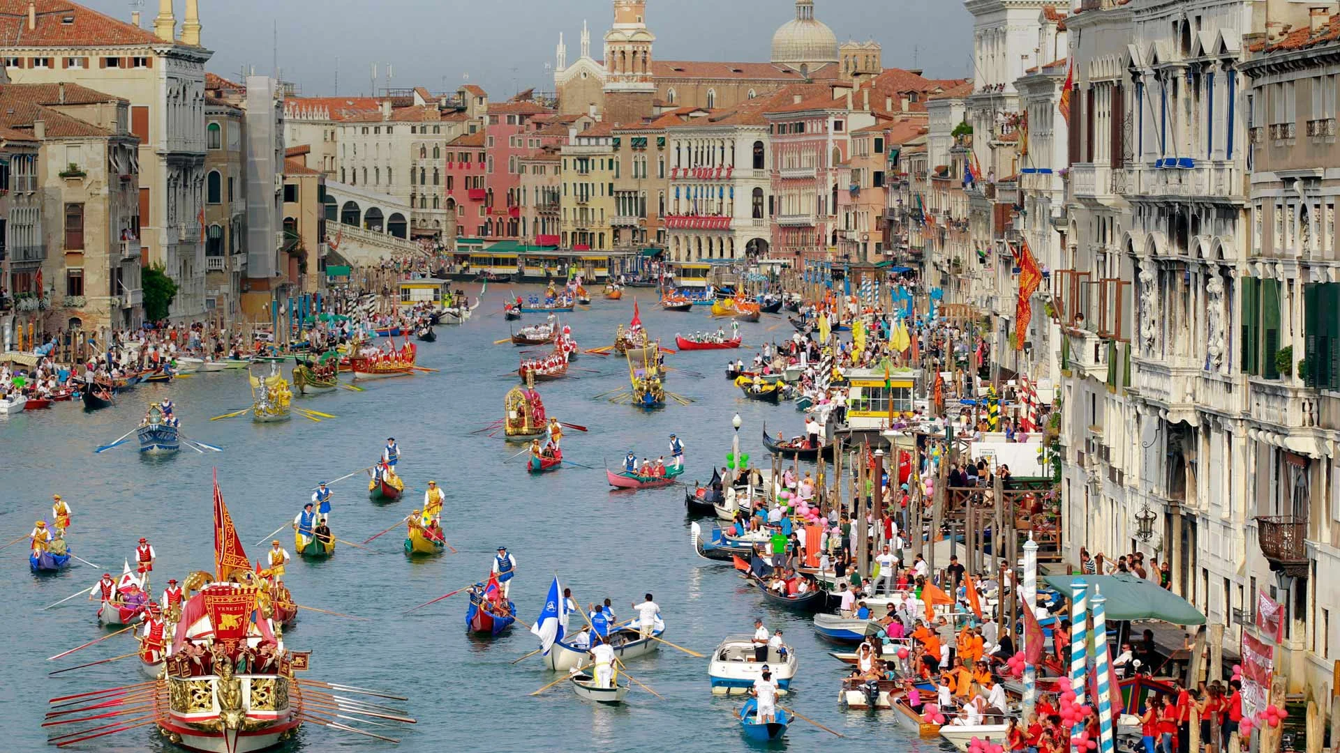 Boaters in historical dress row down the Grand Canal during the Regata Storica in Venice, Italy