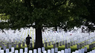 The 3rd US Infantry Regiment honors America's fallen soldiers during the 'Flags In' ceremony for Memorial Day, Arlington National Cemetery, Virginia